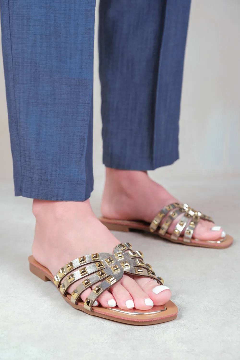 EDRIAH STUDDED GLADIATOR SANDALS WITH METALLIC STUDS IN GOLD